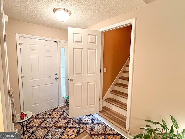 6830 Peeksville Rd, Mcdonough, GA 30252 - entrance foyer with stairway and a textured ceiling