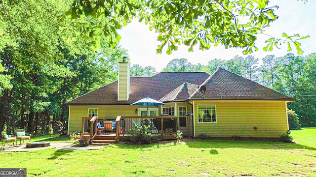 6830 Peeksville Rd, Mcdonough, GA 30252 - back of house with a fire pit, a wooden deck, a chimney, and a yard