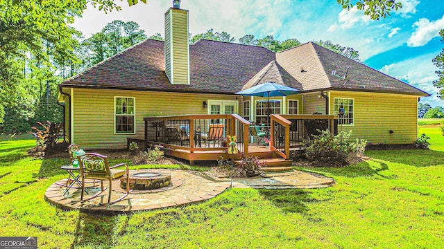 6830 Peeksville Rd, Mcdonough, GA 30252 - rear view of property with a fire pit, a deck, a lawn, a chimney, and a patio area
