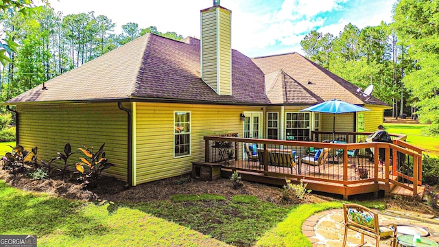 6830 Peeksville Rd, Mcdonough, GA 30252 - rear view of property with a wooden deck, a chimney, a lawn, and a shingled roof