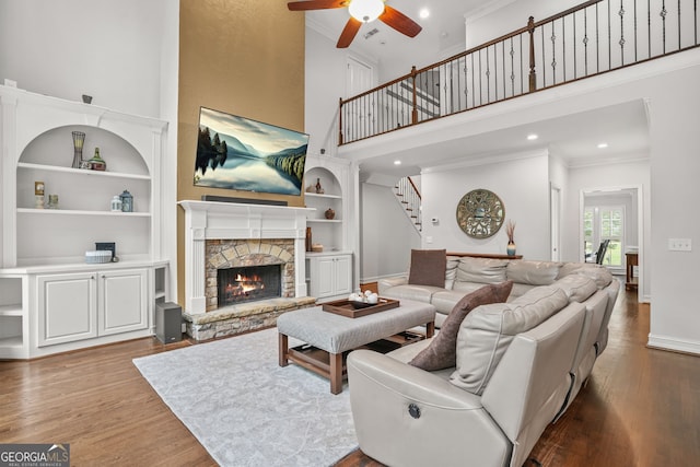 702 Crescent Cir, Canton, GA 30115 - living area with ceiling fan, a towering ceiling, ornamental molding, stairs, and wood finished floors