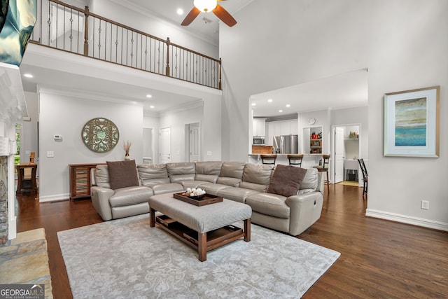 702 Crescent Cir, Canton, GA 30115 - living area with a high ceiling, a ceiling fan, ornamental molding, dark wood-style floors, and baseboards