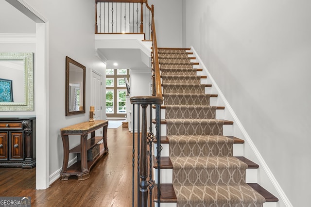 702 Crescent Cir, Canton, GA 30115 - stairs with ornamental molding, wood finished floors, baseboards, and a towering ceiling