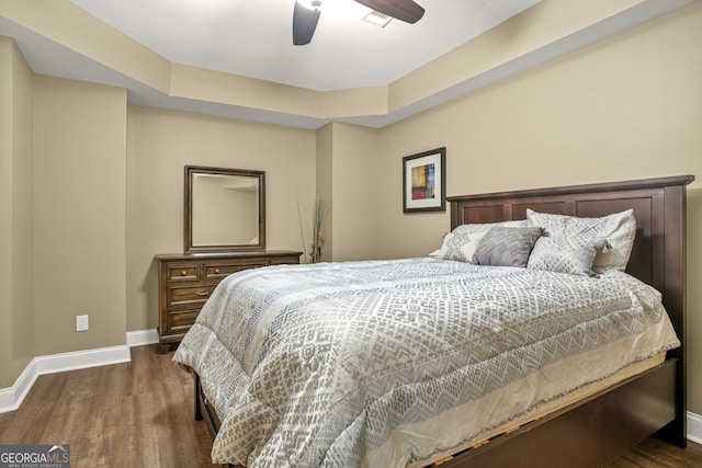 702 Crescent Cir, Canton, GA 30115 - bedroom featuring baseboards, dark wood-style flooring, ceiling fan, and a raised ceiling
