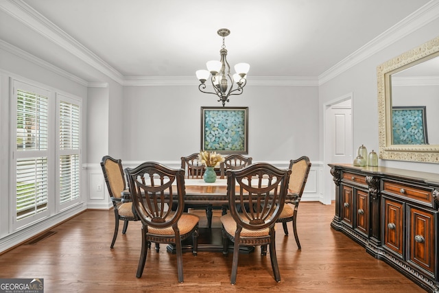 702 Crescent Cir, Canton, GA 30115 - dining room featuring a chandelier, ornamental molding, dark wood-type flooring, wainscoting, and a decorative wall
