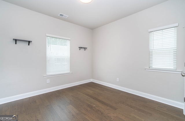 831 Corsiglia Farm Flts, Marietta, GA 30060 - empty room featuring baseboards and dark wood-type flooring