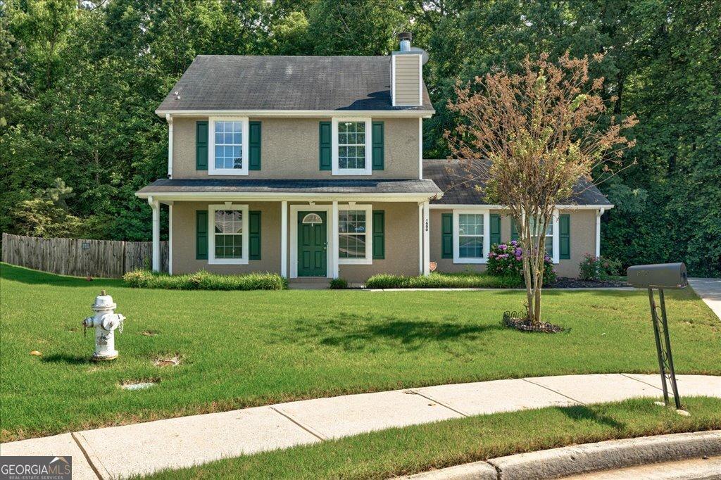 1600 Coal Shovel Trl NE, Conyers, GA 30013 - view of front facade featuring a chimney, stucco siding, and a porch