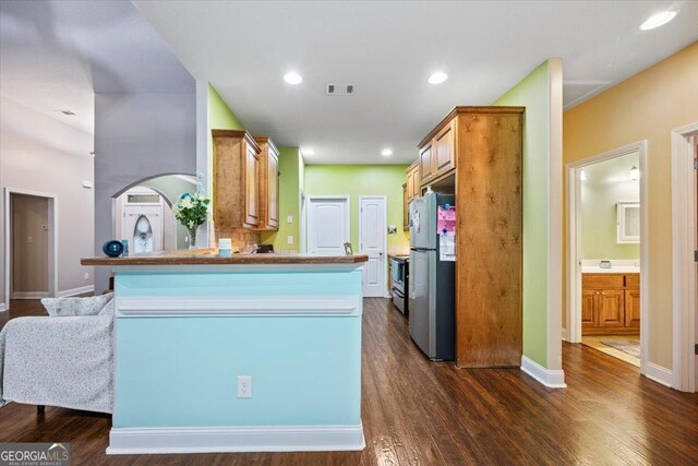161 Presidents Way, Forsyth, GA 31029 - kitchen with appliances with stainless steel finishes, dark wood-style floors, a peninsula, and recessed lighting