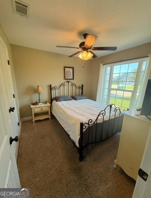 4961 Bentwood Ct, Valdosta, GA 31601 - bedroom featuring carpet flooring, a ceiling fan, and a textured ceiling