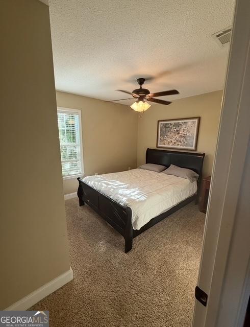 4961 Bentwood Ct, Valdosta, GA 31601 - bedroom featuring baseboards, carpet flooring, a textured ceiling, and ceiling fan