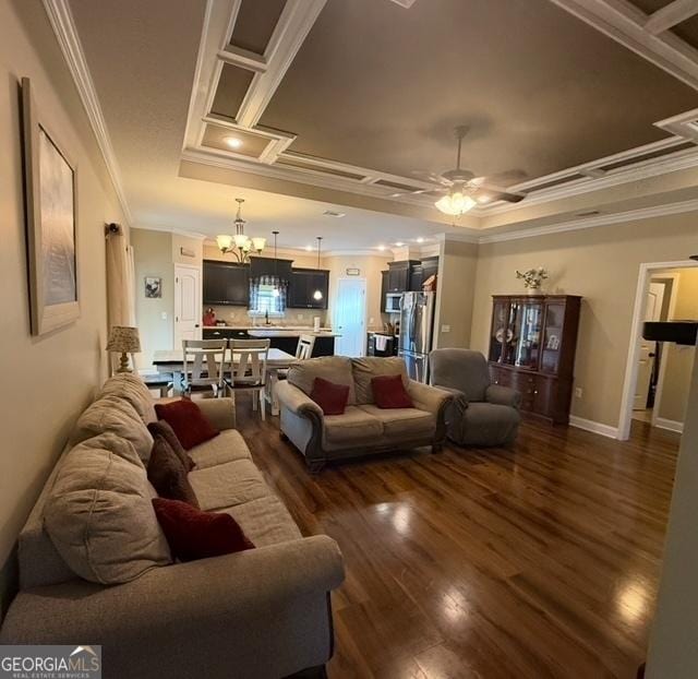4961 Bentwood Ct, Valdosta, GA 31601 - living room featuring ornamental molding, a tray ceiling, dark wood-type flooring, a ceiling fan, and a chandelier