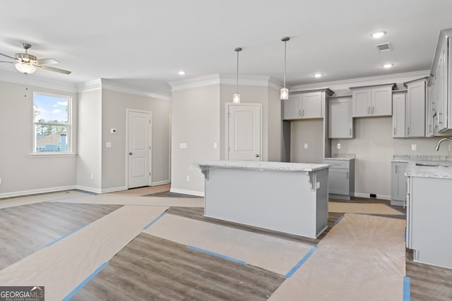 2721 Fareed St, Douglasville, GA 30135 - kitchen featuring gray cabinetry, a sink, a ceiling fan, ornamental molding, and baseboards