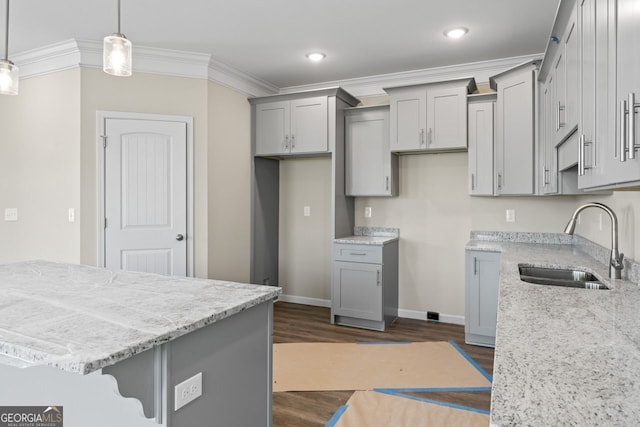 2721 Fareed St, Douglasville, GA 30135 - kitchen featuring gray cabinets, a sink, light stone counters, dark wood-style flooring, and crown molding