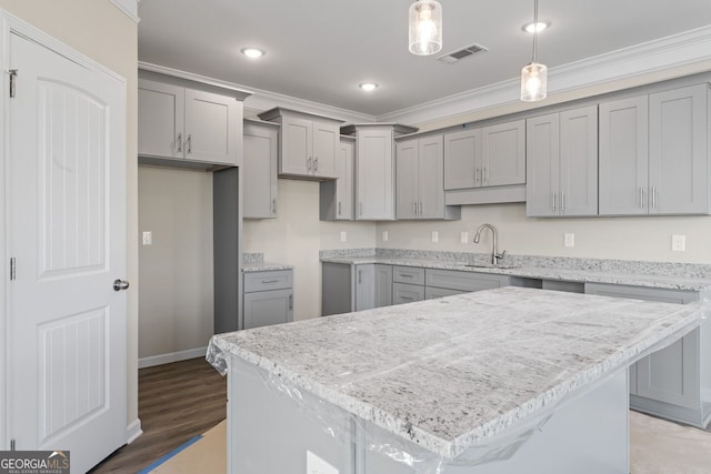 2721 Fareed St, Douglasville, GA 30135 - kitchen featuring gray cabinetry, a sink, ornamental molding, pendant lighting, and recessed lighting