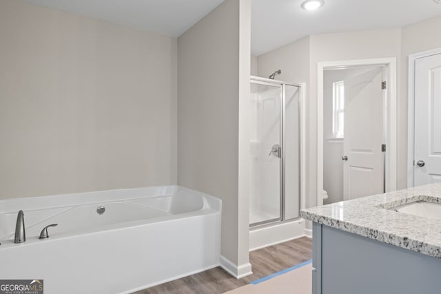 2721 Fareed St, Douglasville, GA 30135 - bathroom with wood finished floors, vanity, a stall shower, and a garden tub