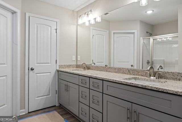 2721 Fareed St, Douglasville, GA 30135 - full bath featuring double vanity, a shower stall, and wood finished floors
