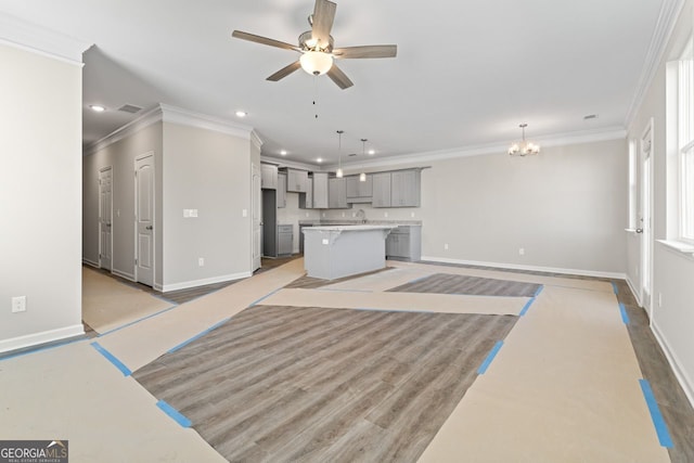 2721 Fareed St, Douglasville, GA 30135 - unfurnished living room with ornamental molding, baseboards, recessed lighting, ceiling fan, and a chandelier
