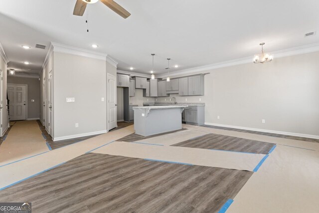 2721 Fareed St, Douglasville, GA 30135 - unfurnished living room with ornamental molding, recessed lighting, baseboards, a ceiling fan, and a chandelier