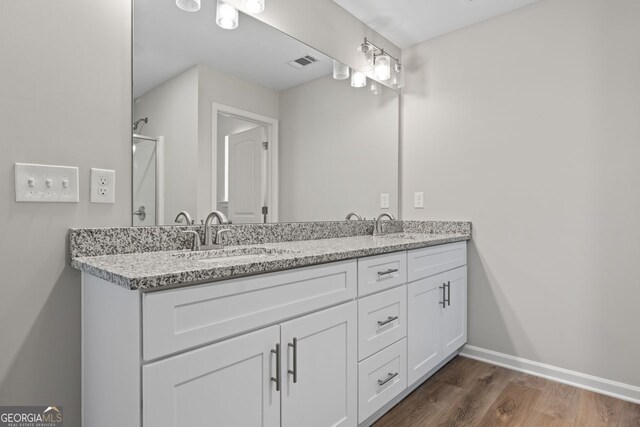 2811 Fareed, Douglasville, GA 30135 - full bath with double vanity, wood finished floors, baseboards, and a shower