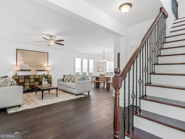 741 SE Knox Dr SE, Atlanta, GA 30315 - living room featuring dark wood-type flooring, stairway, ceiling fan, and a chandelier