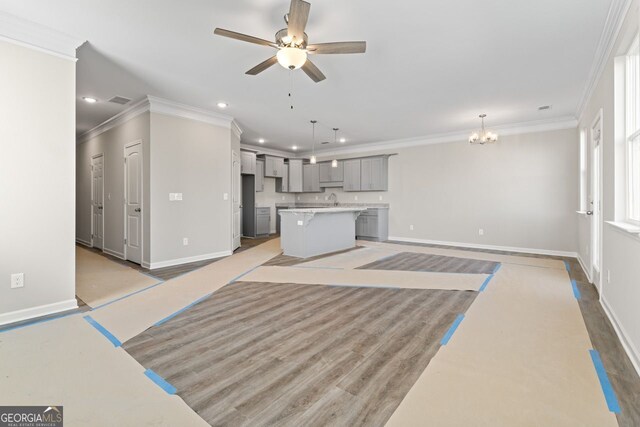 2821 Fareed, Douglasville, GA 30135 - unfurnished living room with ornamental molding, baseboards, recessed lighting, ceiling fan, and a chandelier
