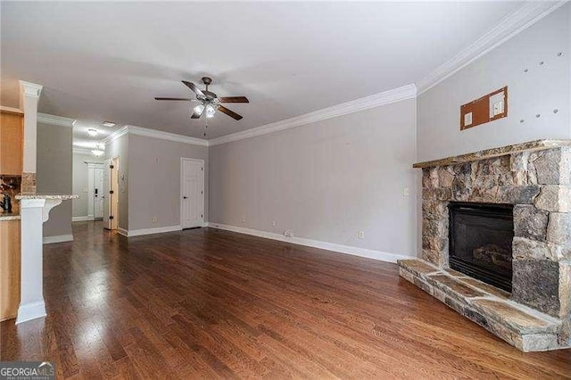 2500 Morgan Chase Dr, Buford, GA 30519 - unfurnished living room featuring ceiling fan, a stone fireplace, wood finished floors, and crown molding