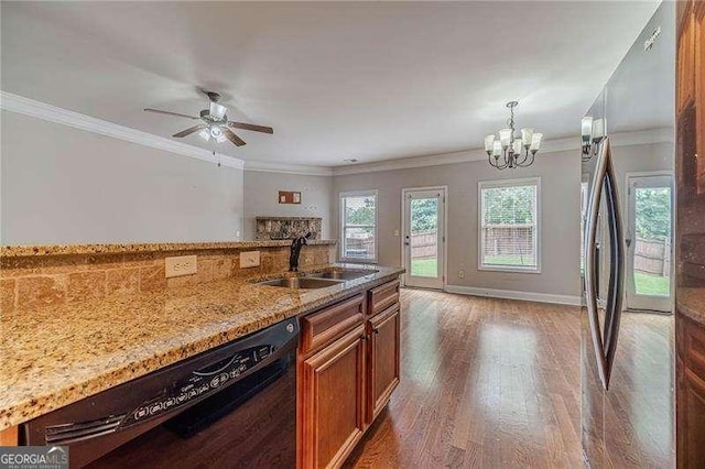 2500 Morgan Chase Dr, Buford, GA 30519 - kitchen with dishwasher, brown cabinets, wood finished floors, light stone counters, and a chandelier