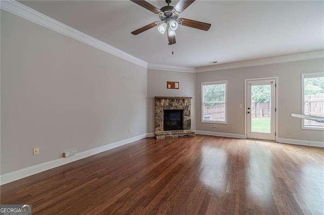 2500 Morgan Chase Dr, Buford, GA 30519 - unfurnished living room with wood finished floors, ceiling fan, a stone fireplace, and ornamental molding