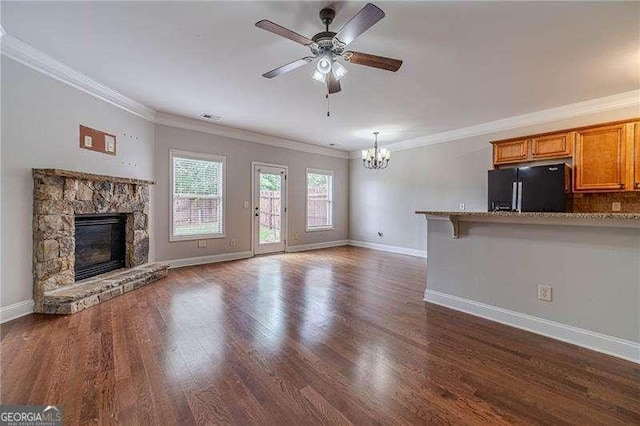 2500 Morgan Chase Dr, Buford, GA 30519 - unfurnished living room with a chandelier, a ceiling fan, ornamental molding, dark wood-type flooring, and a fireplace