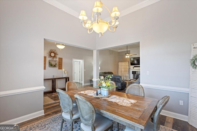 2977 William Few Pkwy, Evans, GA 30809 - dining area featuring a chandelier, wood finished floors, crown molding, a fireplace, and baseboards