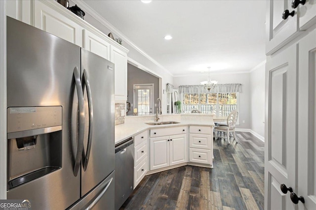 2977 William Few Pkwy, Evans, GA 30809 - kitchen featuring appliances with stainless steel finishes, a sink, crown molding, a chandelier, and dark wood-style floors