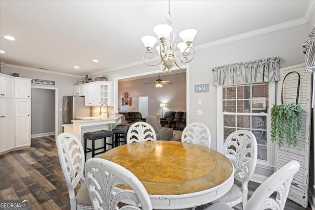 2977 William Few Pkwy, Evans, GA 30809 - dining space with a chandelier, dark wood-type flooring, recessed lighting, ornamental molding, and a ceiling fan