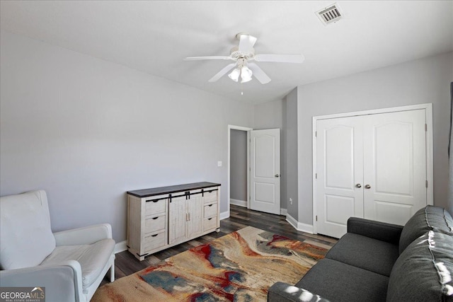 2977 William Few Pkwy, Evans, GA 30809 - living room with dark wood finished floors, ceiling fan, and baseboards