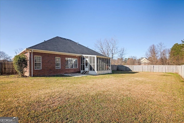 2977 William Few Pkwy, Evans, GA 30809 - back of property featuring a sunroom, brick siding, a patio area, and a shingled roof