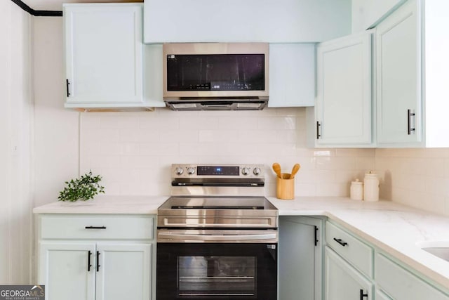 2343 Dawn Dr, Decatur, GA 30032 - kitchen featuring appliances with stainless steel finishes, white cabinetry, and backsplash
