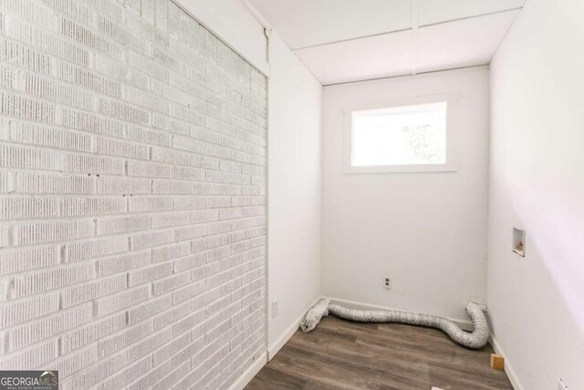 2343 Dawn Dr, Decatur, GA 30032 - washroom featuring dark wood-style flooring, hookup for a washing machine, electric dryer hookup, brick wall, and baseboards