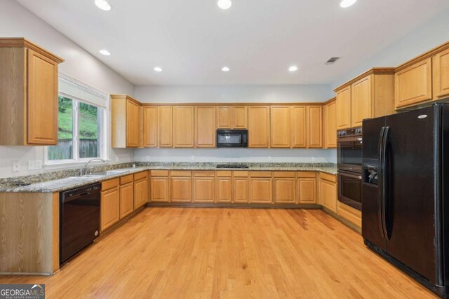 5937 Sharp Dr SE, Mableton, GA 30126 - kitchen featuring black appliances, light wood finished floors, recessed lighting, and light stone counters