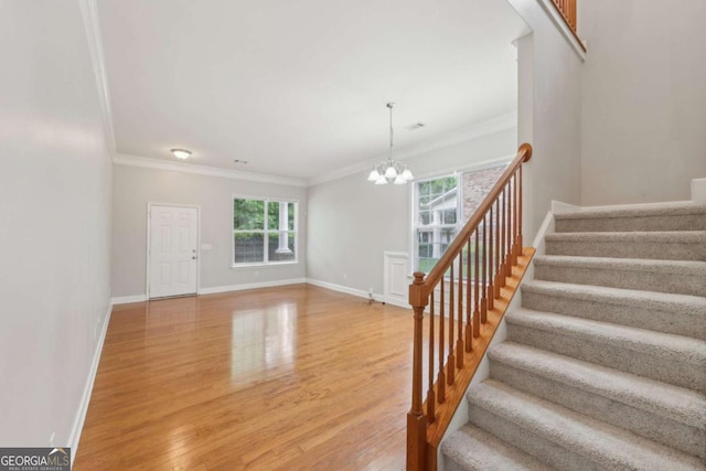 5937 Sharp Dr SE, Mableton, GA 30126 - stairway with a chandelier, ornamental molding, and wood finished floors