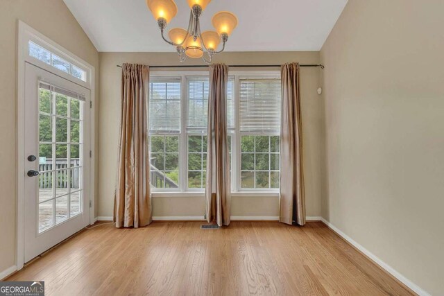 4815 Rapids Cir NW, Acworth, GA 30102 - entryway featuring light wood finished floors, a chandelier, and lofted ceiling