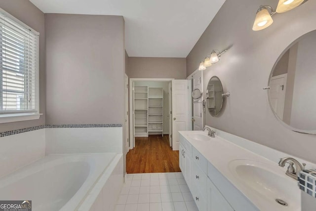 4815 Rapids Cir NW, Acworth, GA 30102 - full bath with double vanity, a garden tub, tile patterned flooring, and a spacious closet