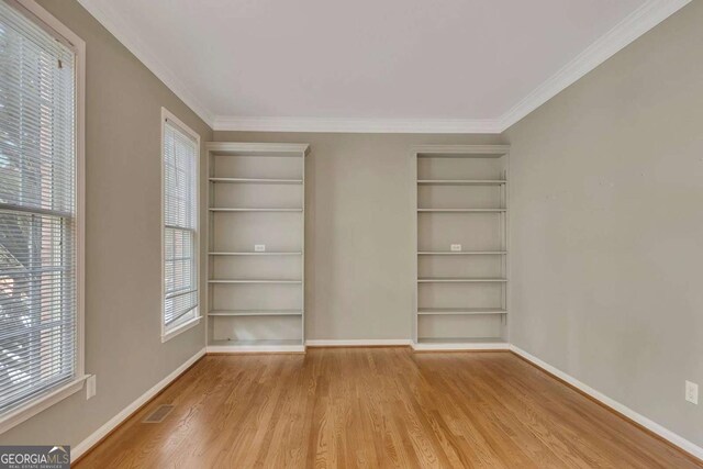 4815 Rapids Cir NW, Acworth, GA 30102 - unfurnished room featuring wood finished floors, plenty of natural light, built in features, and ornamental molding