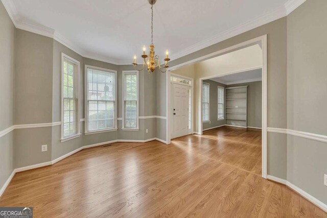 4815 Rapids Cir NW, Acworth, GA 30102 - spare room featuring a chandelier, light wood-type flooring, and ornamental molding