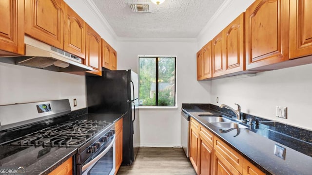 49 Country Ct, Alpharetta, GA 30005 - kitchen featuring appliances with stainless steel finishes, light wood-style floors, a textured ceiling, dark stone countertops, and brown cabinets