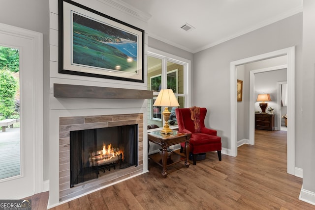 3521 Phoenix Cove Dr, Gainesville, GA 30506 - sitting room featuring wood finished floors, baseboards, a lit fireplace, and ornamental molding