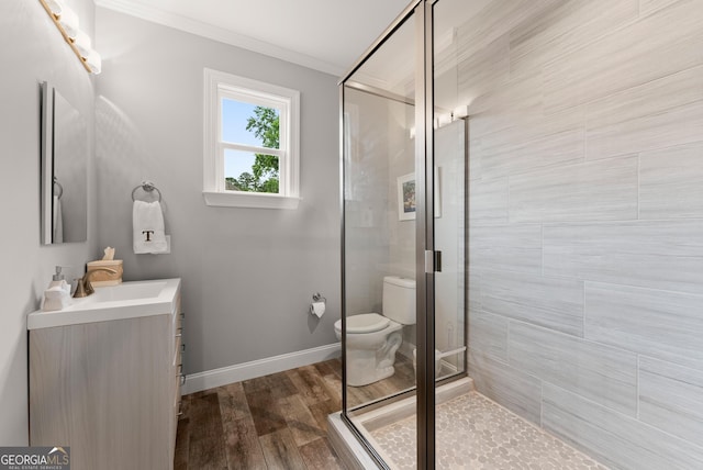 3521 Phoenix Cove Dr, Gainesville, GA 30506 - full bath with vanity, ornamental molding, toilet, a shower stall, and wood finished floors