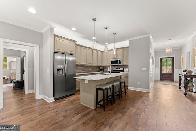 3521 Phoenix Cove Dr, Gainesville, GA 30506 - kitchen with appliances with stainless steel finishes, an island with sink, ornamental molding, a breakfast bar, and wood-type flooring