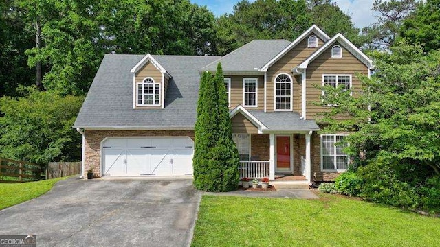 2004 Spicers Ln, Woodstock, GA 30189 - view of front of home featuring covered porch, a garage, driveway, and stone siding