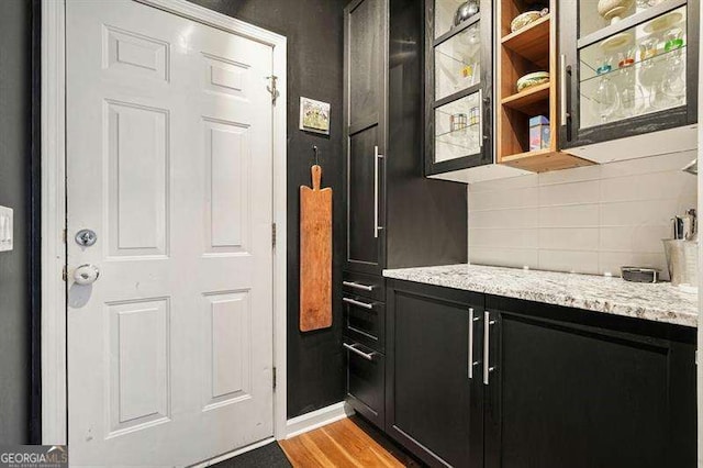 2004 Spicers Ln, Woodstock, GA 30189 - bar area with backsplash, light wood-type flooring, and baseboards