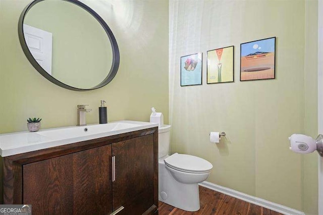 2004 Spicers Ln, Woodstock, GA 30189 - bathroom featuring vanity, toilet, wood finished floors, and baseboards