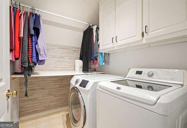 2004 Spicers Ln, Woodstock, GA 30189 - laundry area with washer and clothes dryer, cabinet space, and light floors